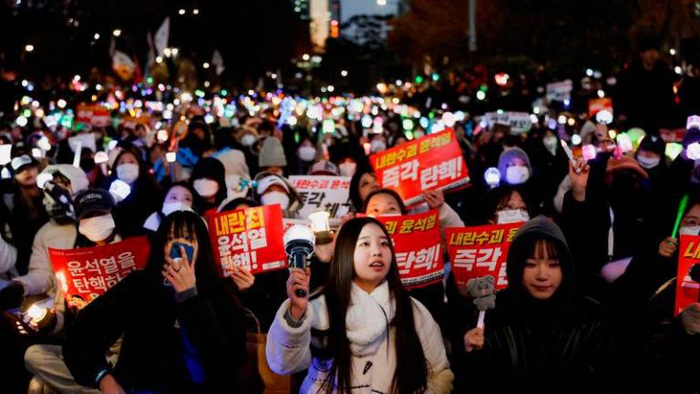 Protesters take part in a rally calling for the impeachment of South Korean President Yoon Suk Yeol, who declared martial law, which was reversed hours later, near the National Assembly in Seoul, South Korea, December 8, 2024. REUTERS/Kim Soo-hyeon