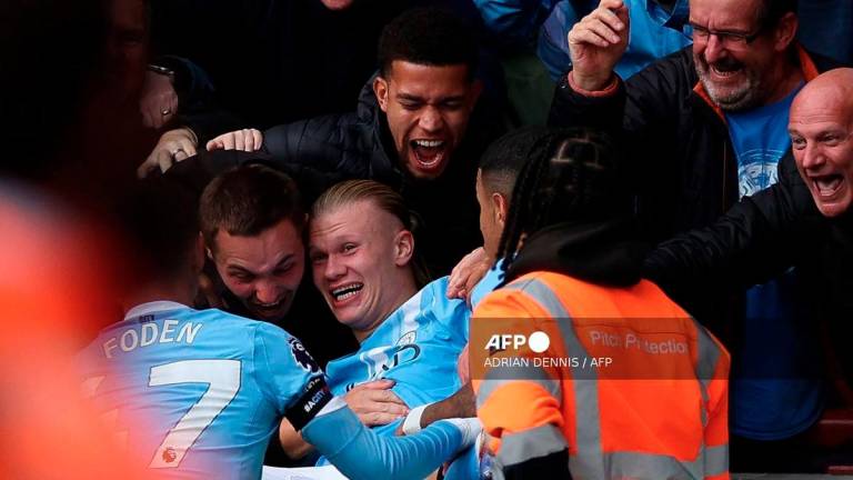 Manchester City's Norwegian striker #09 Erling Haaland celebrates scoring the team's first goal during the English Premier League football match between Brentford and Manchester City at the Gtech Community Stadium in London on October 5, 2025. - AFP