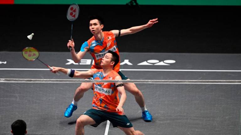 Aaron Chia (C) and Soh Wooi Yik (up) play against Indonesia’s Fajar Alfian and Indonesia’s Muhammad Rian Ardianto in the Men’s Doubles Final at the All England Open Badminton Championships at the Utilita Arena in Birmingham, central England, on March 17, 2024/AFPpix