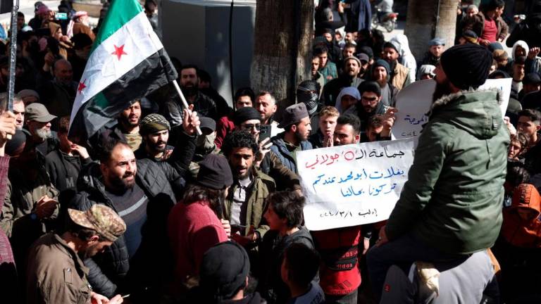 Demonstrators rally in the town of Binnish in Syria’s northwestern Idlib province on March 1, 2024, to protest against Hayat Tahrir al-Sham (HTS), an Islamist group led by Al-Qaeda’s former Syria branch, and calling for the overthrow of the group’s leader/AFPPix