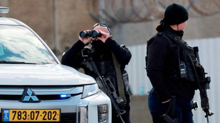 Members of Israeli forces stand guard outside the Israeli military prison, Ofer, on the day Israel is expected to release Palestinian prisoners as part of a hostages-prisoners swap and a ceasefire deal in Gaza between Hamas and Israel, near Ramallah, in the Israeli-occupied West Bank, February 8, 2025. - REUTERSPIX