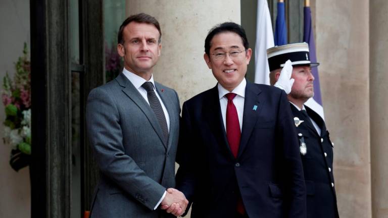 French President Emmanuel Macron welcomes Japan's Prime Minister Fumio Kishida as he arrives for a meeting at the Elysee Palace in Paris, France, May 2, 2024. - REUTERSPIX