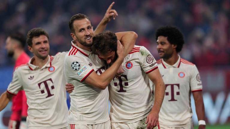 Bayern Munich's German midfielder #08 Leon Goretzka celebrates scoring the 9-2 goal with his teammates including Bayern Munich's English forward #09 Harry Kane during the UEFA Champions League football match FC Bayern Munich vs GNK Dinamo Zagreb in Munich, southern Germany, on September 17, 2024. - AFPPIX