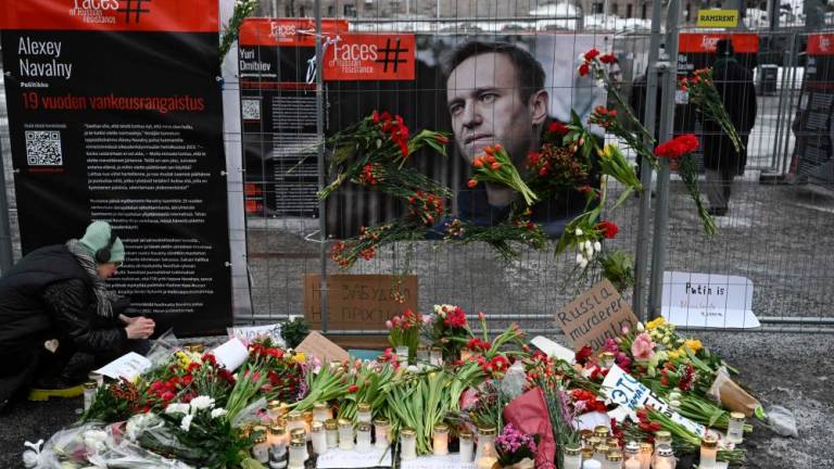 Candles and flowers are brought to a makeshift memorial in Helsinki, Finland on February 17, 2024, one day after Russian officials announced the death of the Kremlin’s most prominent critic Alexei Navalny/AFPPix