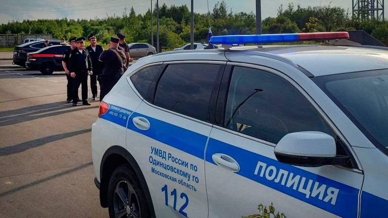 Russian police guards at a self-murder scene at a parking slot in the town of Odintsovo outside Moscow on July 7, 2025. (Photo by STRINGER / AFP)