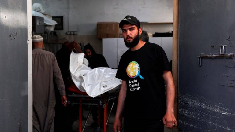 People prepare to transport the bodies of staff members of the US-based aid group World Central Kitchen, at a hospital morgue in Rafah in the southern Gaza Strip on April 3, 2024, two days after a convoy of the NGO was hit in an Israeli strike as battles continue between Israel and the Palestinian militant group Hama/AFPPix