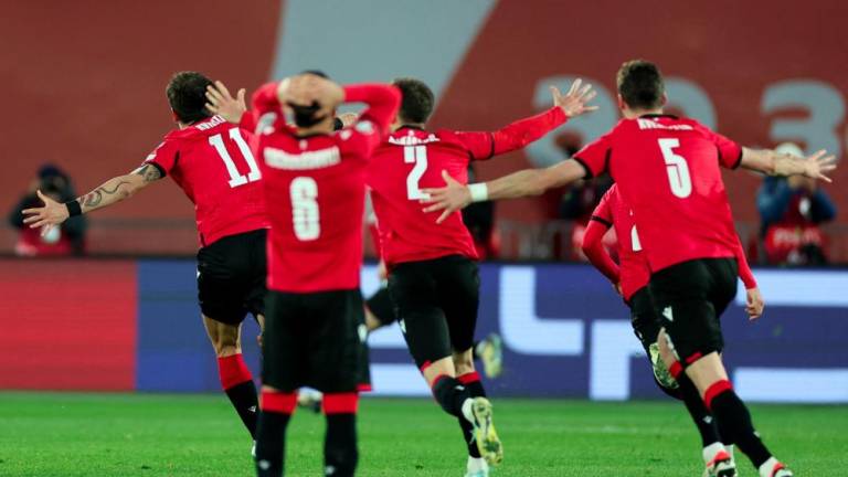Georgia's players celebrate after winning the UEFA EURO 2024 qualifying play-off final football match between Georgia and Greece in Tbilisi on March 26, 2024. - AFPPIX