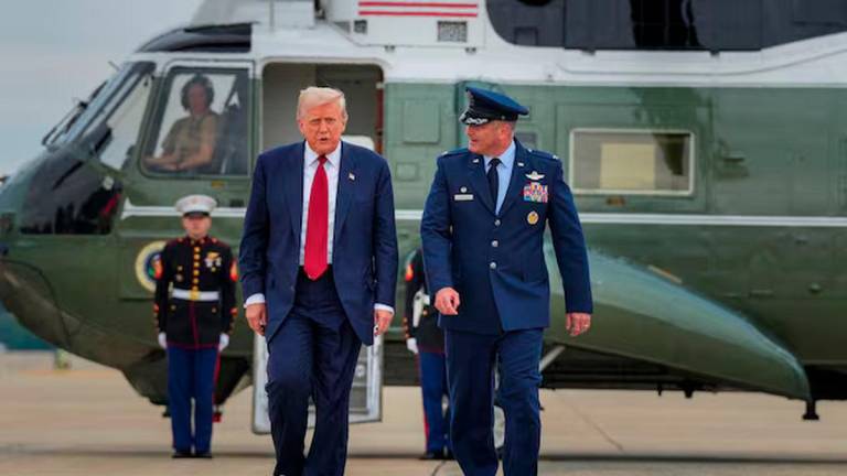 U.S. President Donald Trump walks with Col. Christopher Robinson 89th Airlift Commander after stepping off Marine One at Joint Base Andrews, Maryland, U.S., August 1, 2025. REUTERS/Ken Cedeno