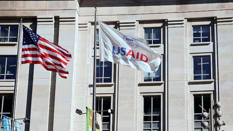 An American flag and USAID flag fly outside the USAID building in Washington, D.C. - REUTERSpix