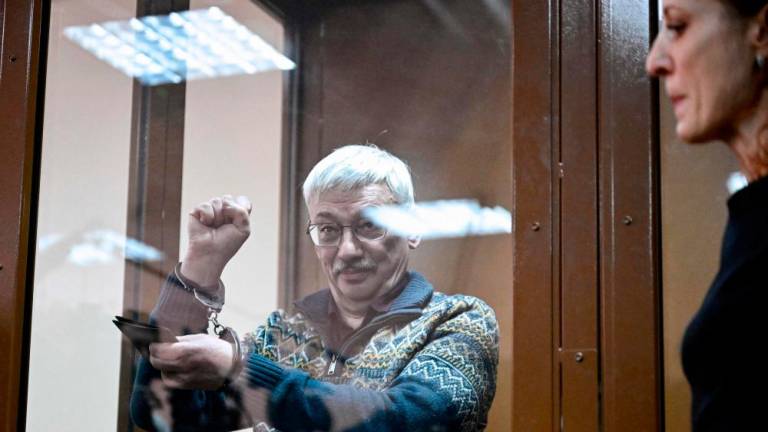 Oleg Orlov, the 70-year-old human rights campaigner and co-chair of the Nobel Prize winning Memorial group, is seen handcuffed after being sentenced to two and a half years in jail on charges of repeatedly “discrediting” the Russian army, in Moscow on February 27, 2024/AFPPix