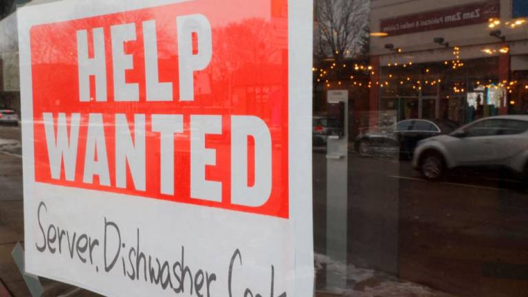 A sign hangs in a restaurant window in Medford, Massachusetts. The US labour market remains fairly tight with fewer Americans applying for unemployment benefits last week. – Reuterspic