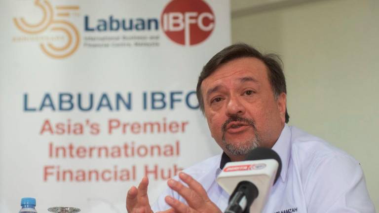 Finance Minister II, Datuk Seri Amir Hamzah Azizan, speaks at a press conference after officiating the 35th Anniversary of the Labuan International Business and Financial Centre (IBFC) Malaysia at Labuan International School today. - BERNAMA
