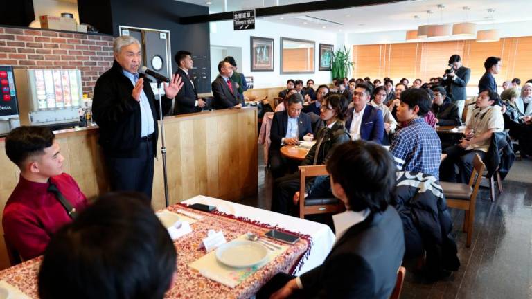 Deputy Prime Minister Datuk Seri Dr Ahmad Zahid Hamidi (second, left) addressing the Deputy Prime Minister's Lunch with Malaysian Students in Japan, here today. - BERNAMAPIX