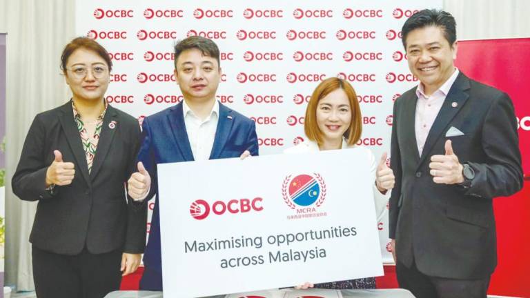 From left: MCRA vice-president Ada Zheng, Gao, Leong and OCBC Bank managing director and branch &amp; premier banking head Teo Choon Huat.