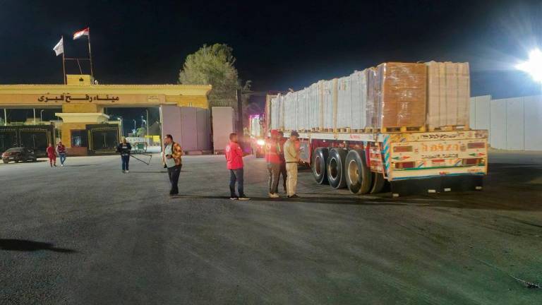 Trucks carrying humanitarian aid line up at the Rafah border on the Egypt side and enter the crossing into the Gaza Strip, after a ceasefire between Israel and Hamas in Gaza went into effect, in Rafah, Egypt, October 16, 2025. - REUTERS/Stringer