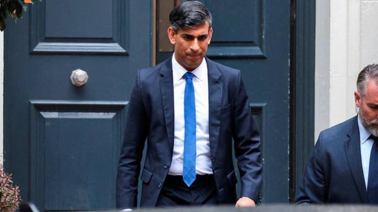 Outgoing British Prime Minister Rishi Sunak walks outside Conservative Campaign Headquarters, following the results of the general election, in London, Britain, July 5, 2024. - REUTERSpix