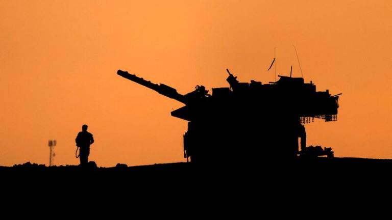 The silhouettes of a military vehicle and a soldier are seen near the Gaza border, amid the ongoing conflict in Gaza between Israel and Hamas, in Israel, December 16, 2024. - REUTERSPIX