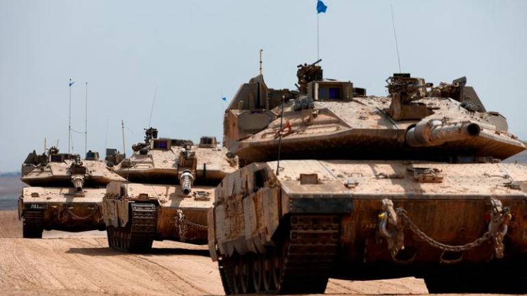 Israeli tanks make their way towards the border with the Gaza Strip, amid the ongoing conflict between Israel and Hamas, in southern Israel, October 6, 2024. - REUTERSPIX