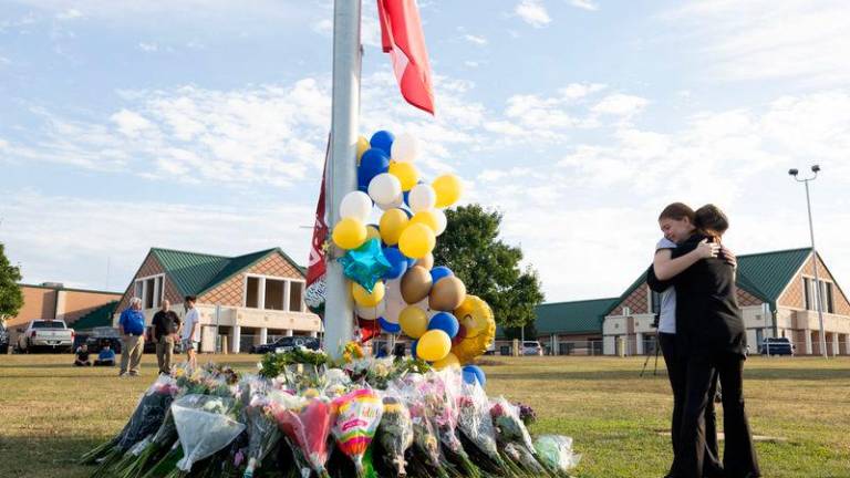 Students embrace near a makeshift memorial at Apalachee High School on September 5, 2024 in Winder, Georgia/AFPpix