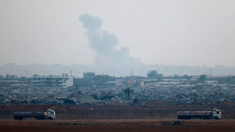 Trucks loaded with aid drive on the Israel-Gaza border as they make their way into Gaza, as seen from Israel, June 7, 2025. REUTERSpix