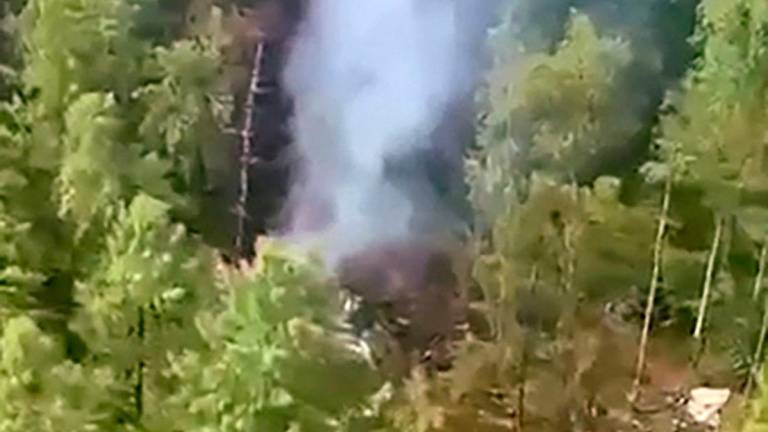 This video grab from a handout footage released by the Eastern Interregional Directorate for Transport of the Russian Investigative Committee on July 24, 2025, shows an aerial view of the crash site of the Antonov AN-24 passenger plane outside the town of Tynda in Russia’s far eastern Amur region - Photo by Handout / INVESTIGATIVE COMMITTEE OF RUSSIA / AFP