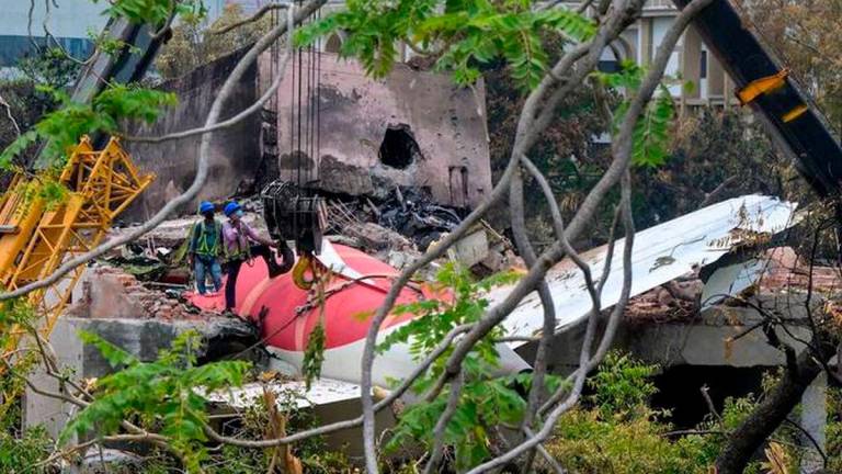Cranes removing the tail from the wreckage after the Air India Flight 171 crash on June 14, 2025. (AFP)