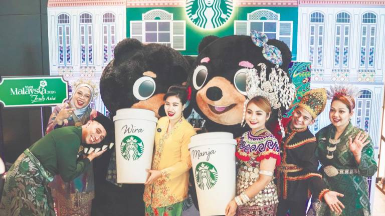 Mascots Wira and Manja with Starbucks Malaysia Hospitality Specialists.