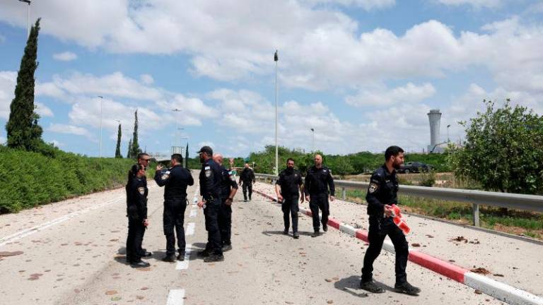 Security forces work at the site of a missile attack, launched from Yemen, at the entrance of Ben Gurion Airport, in Tel Aviv, Israel May 4, 2025. REUTERSpix