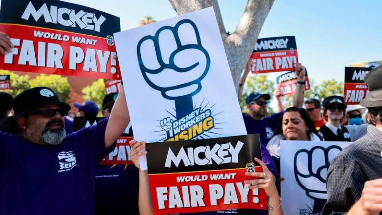 Workers gather with signs as the Teamsters union and Disney cast members demand fair wages at a rally outside Disneyland, in Anaheim, California, U.S., July 17, 2024 / REUTERSpix