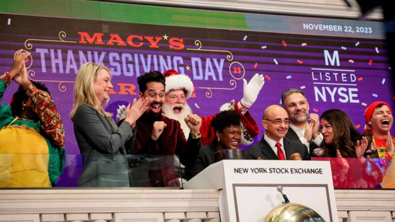 Macy's Santa Claus and other guests ring the opening bell to celebrate the 97th Macy’s Thanksgiving Day Parade at the New York Stock Exchange on Wednesday. – Reuterspic