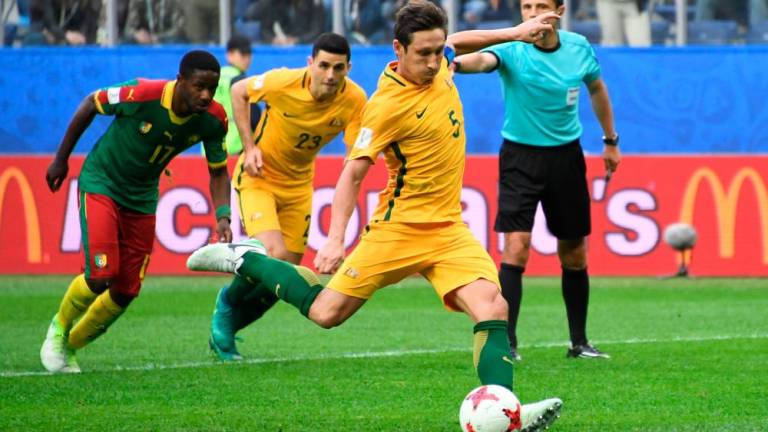 Australia’s midfielder Mark Milligan shoots to score in a penalty during the 2017 Confederations Cup group B - AFPpix