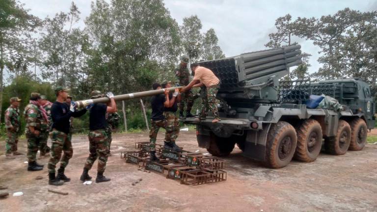 Cambodian soldiers reload the BM-21 multiple rocket launcher in Preah Vihear province on July 24, 2025. (Photo by AFP)