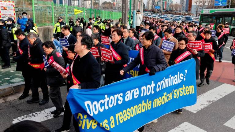 South Korean doctors march to protest against the government medical policy in front of the Presidential office in Seoul, South Korea, February 25, 2024. - REUTERSPIX