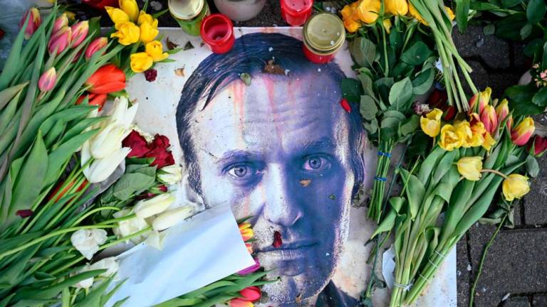 Flowers are seen placed around a portrait of late Russian opposition leader Alexei Navalny at a makeshift memorial in Frankfurt am Main, western Germany, on February 29, 2024/AFPpix