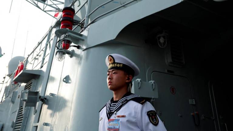 A member of the Chinese People's Liberation Army (PLA) Navy stands guard on the Shijiazhuang, a Type 051C guided-missile destroyer, as the Navy opens warships for public viewing to mark its upcoming 75th founding anniversary, at the port in Qingdao, Shandong province, China April 20, 2024. - REUTERSPIX
