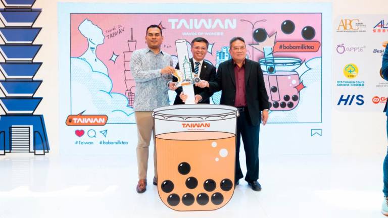 (From left) Malaysian Association of Tour &amp; Travel Agents deputy president Sheikh Awadh Sheikh Abdullah, Taiwan Tourism Administration KL Office director Abe Chou and Malaysian Chinese Tourism Association president Paul Paw launching the Taiwan Travel Fair.