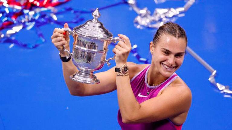 Belarus's Aryna Sabalenka holds up the trophy after defeating USA's Jessica Pegula during their women's final match on day thirteen of the US Open tennis tournament at the USTA Billie Jean King National Tennis Center in New York City, on September 7, 2024. - AFPPIX