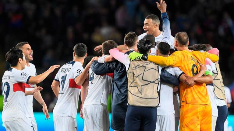 Paris Saint-Germain's forward Kylian Mbappe (Top) and teammates celebrate after winning the UEFA Champions League quarter-final second leg football match between FC Barcelona and Paris SG at the Estadi Olimpic Lluis Companys in Barcelona today. - AFPpix