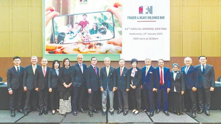 F&amp;NHB chairman Tengku Syed Badarudin Jamalullail (eight from left), and Lim (seventh from left), with board of directors at the 63rd AGM at Sime Darby Convention Centre.