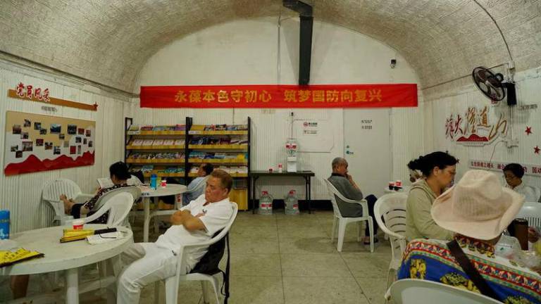 People cool off in an air raid shelter amid a red alert for heatwave in Hangzhou, Zhejiang province - REUTERSpix