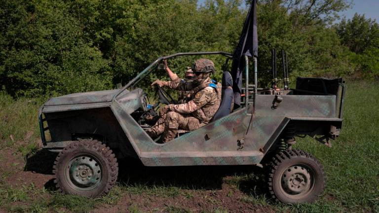 Soldiers from the 3rd operation Spartan brigade of the national guard of Ukraine drive a buggy during a demonstration to AFP, at an undisclosed location, not far from the front line, in the region of Dnipropetrovsk, Ukraine, on June 14, 2025, amid the russian invasion of Ukraine. Ukrainian army logistics have become the priority target for Russian drones. - AFPPIX