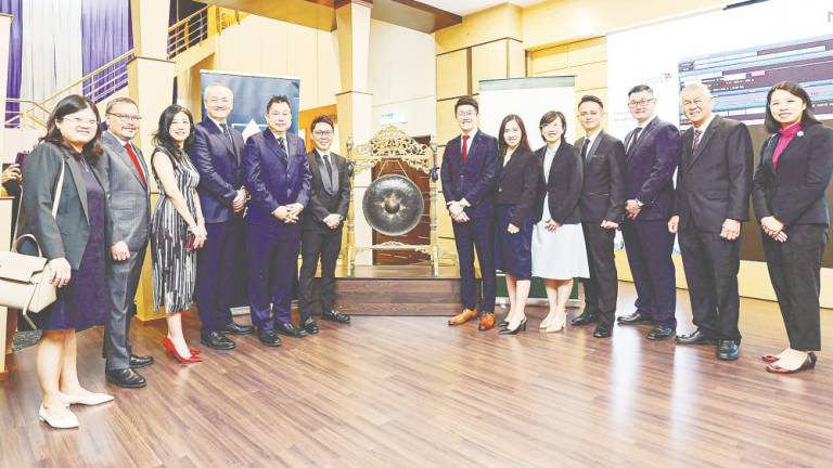 Chan (sixth from left) with his directors, management team and Alliance Islamic Bank officials at the listing.