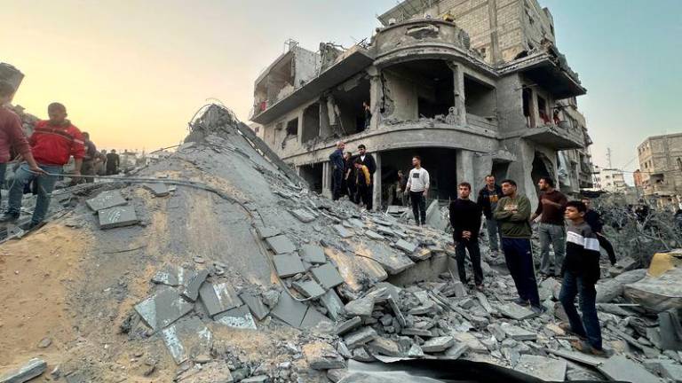 Palestinians gather at the site of an Israeli strike on a house, in Jabalia in the northern Gaza Strip - REUTERSpix