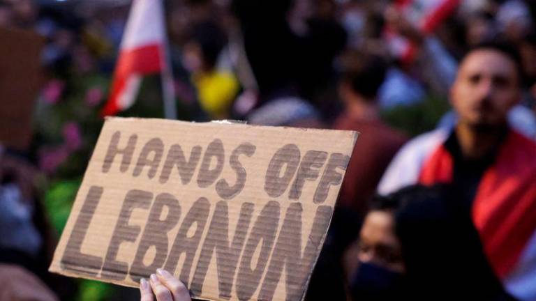 A person holds a sign as people gather to protest the escalation of conflict between Israel and Hezbollah, in New York City - REUTERSpix