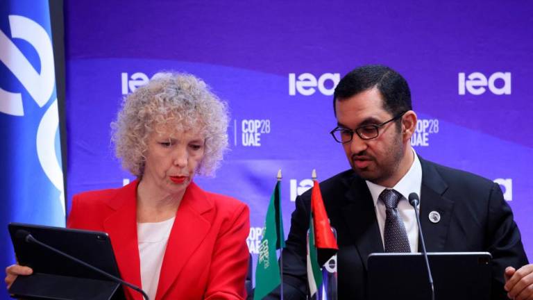 Sultan Ahmed al-Jaber (right) talking to Germany’s state secretary and special envoy for international climate action Jennifer Morgan during a high-level roundtable on COP energy and climate commitments organised by the IEA at its headquarters in Paris on Tuesday. – AFPpic