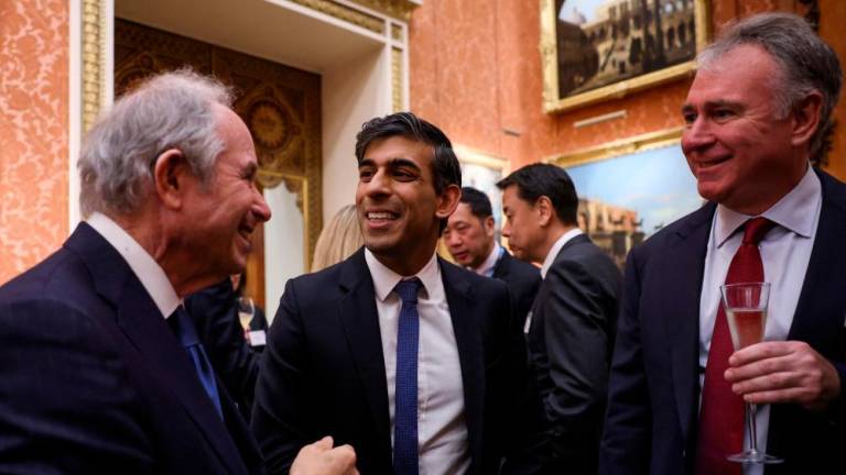 Sunak (centre) speaks with Blackstone CEO Stephen A. Schwarzman (left) during a reception at Buckingham Palace on Monday to mark the conclusion of the Global Investment Summit. – AFPpic
