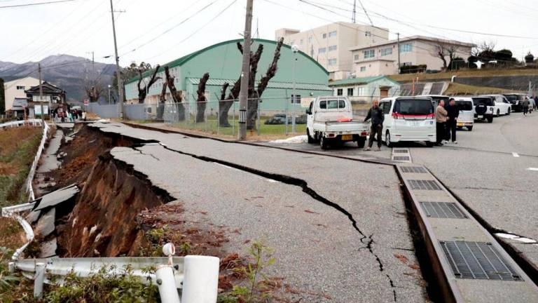Pavement was left cracked in the city of Wajima, after a major 7.5 magnitude earthquake struck Japan’s Noto region © Yusuke FUKUHARA / Yomiuri Shimbun/AFP / Yomiuri Shimbun