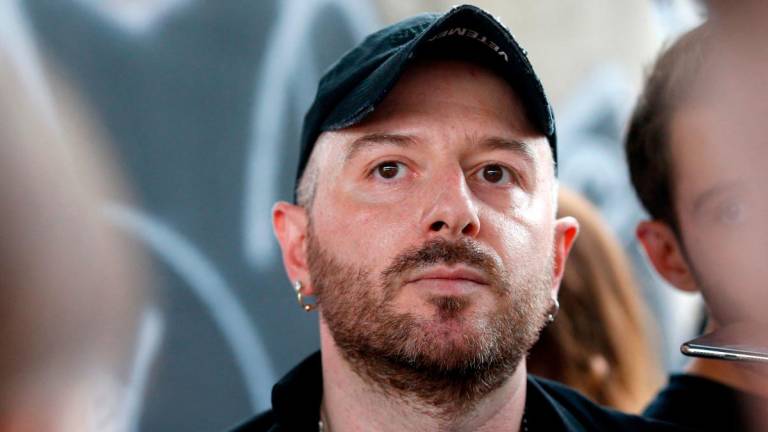 (FILES) Fashion designer for Vetements, Demna Gvasalia talks to people at the end of his men and women’s Spring/Summer 2019 collection fashion show, in Paris, on July 1, 2018. (Photo by GEOFFROY VAN DER HASSELT / AFP)