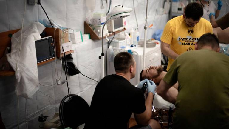 Ukrainian doctors treat a soldier injured by shrapnel from Russian explosive drones at a medical stabilisation centre of the 3rd Operational Brigade of the National Guard of Ukraine, in an undisclosed location near Pokrovsk, eastern Ukraine, on June 7, 2025, amid the Russian invasion of Ukraine.