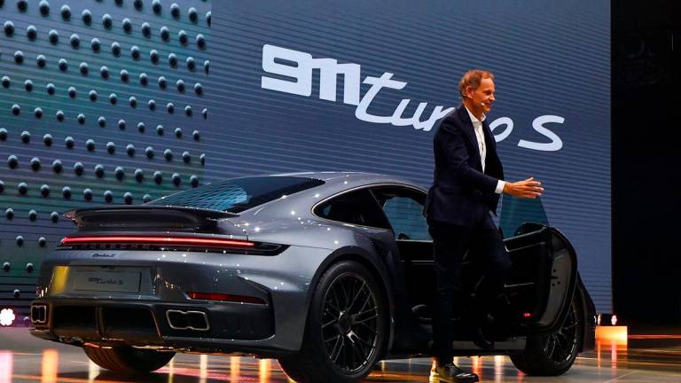 Oliver Blume, CEO of Volkswagen arrives in the new Porsche 911 Turbo S, during a media preview ahead of the IAA Munich auto show, in Munich, Germany, September 7, 2025. REUTERS/Kai Pfaffenbach